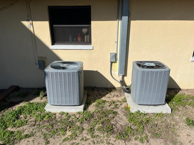 Boost your home's efficiency with a professional dual-system AC installation. This setup features two high-performance residential AC condenser units mounted on precision-leveled concrete pads to ensure maximum airflow and drainage. As your local Central F Boost your home's efficiency with a professional dual-system AC installation. This setup features two high-performance residential AC condenser units mounted on precision-leveled concrete pads to ensure maximum airflow and drainage. As your local Central F